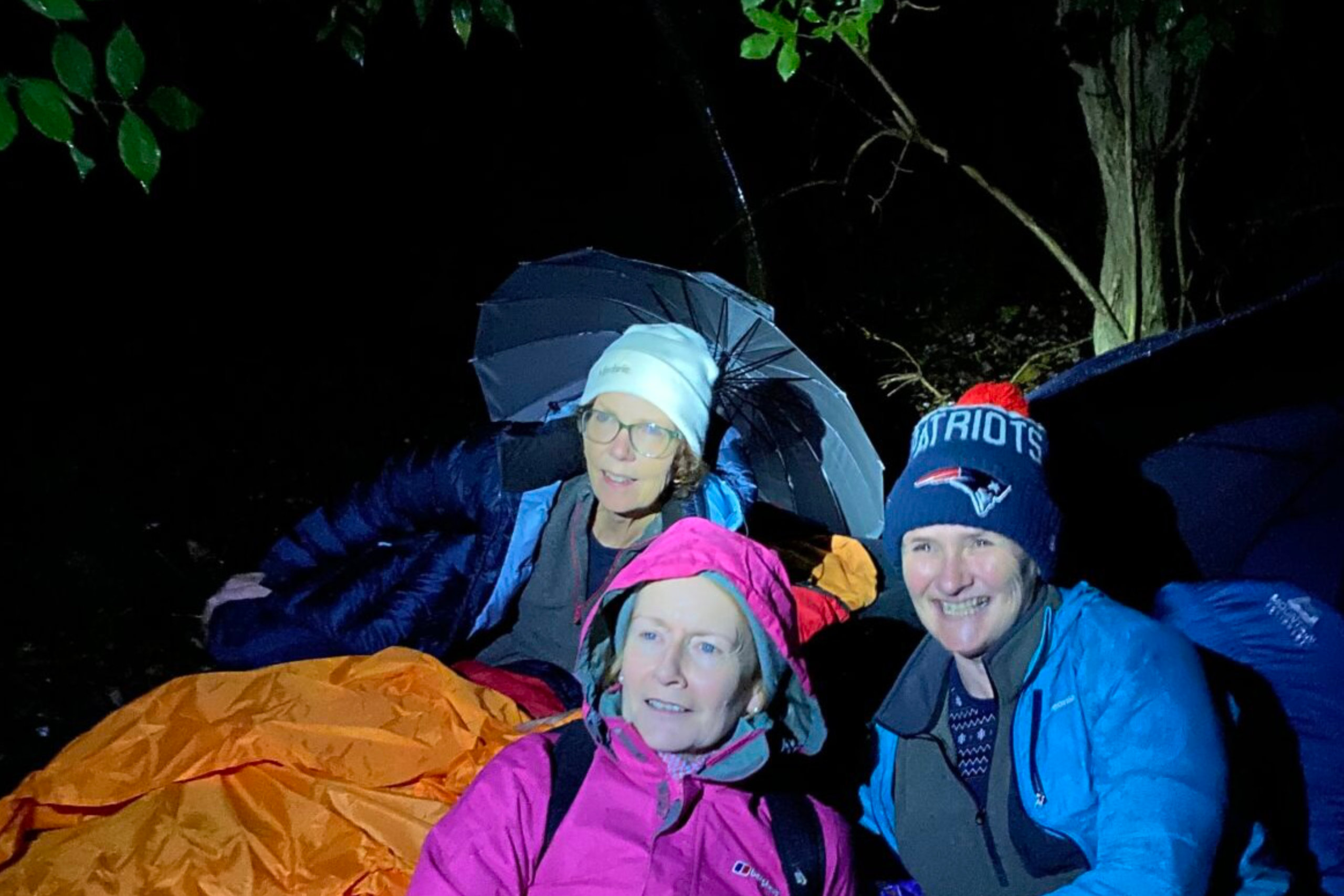 Irene Tracey and others at CEO sleepout 2023 huddled in sleeping bags