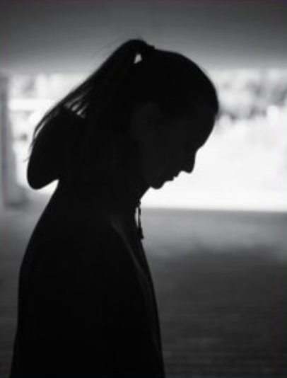 A silhouette of a woman in need