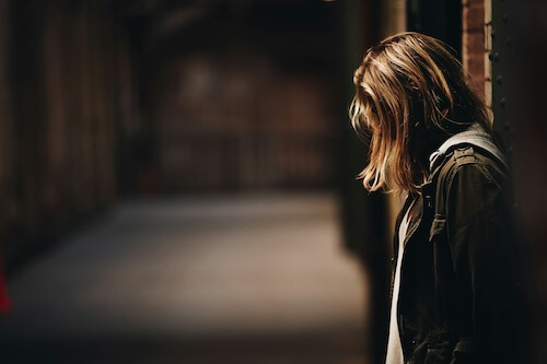 Women need help picture of a homeless young woman out on the street at night by Eric Ward on Unsplash.com