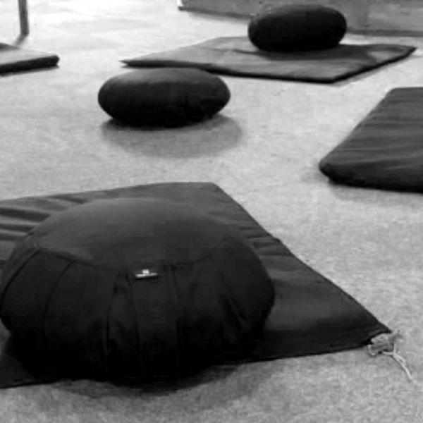 Mindful meditation cushions and mats set out on the floor